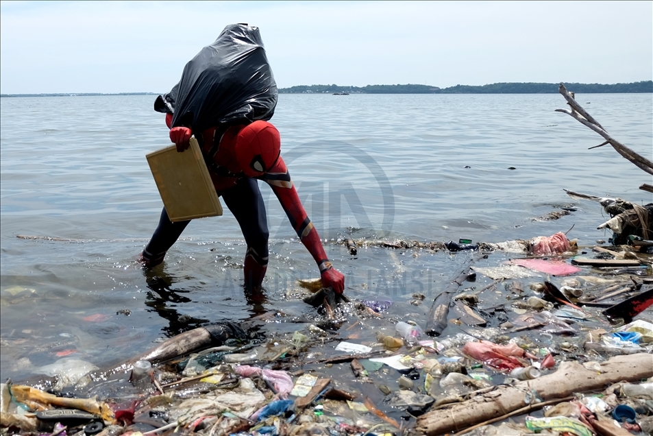 Pria Berkostum Super Hero Bersihkan Laut Saat Hari Bumi Internasional