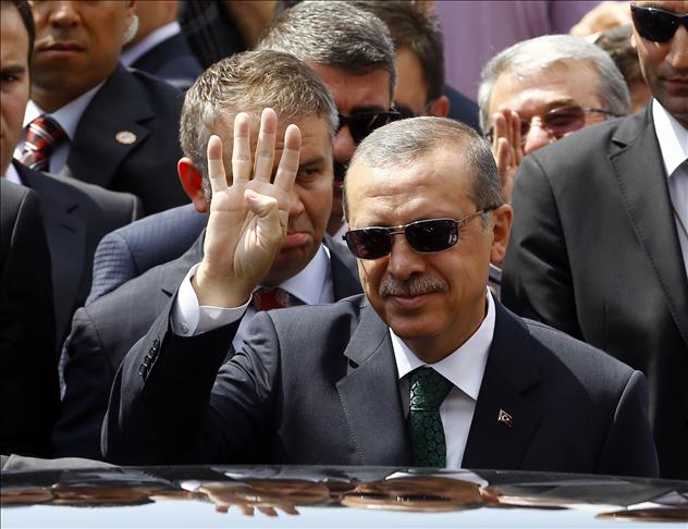 Turkish PM greets crowd with 'Rabaa sign'