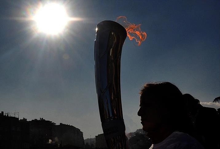 Olympic flame plunges into world’s deepest lake