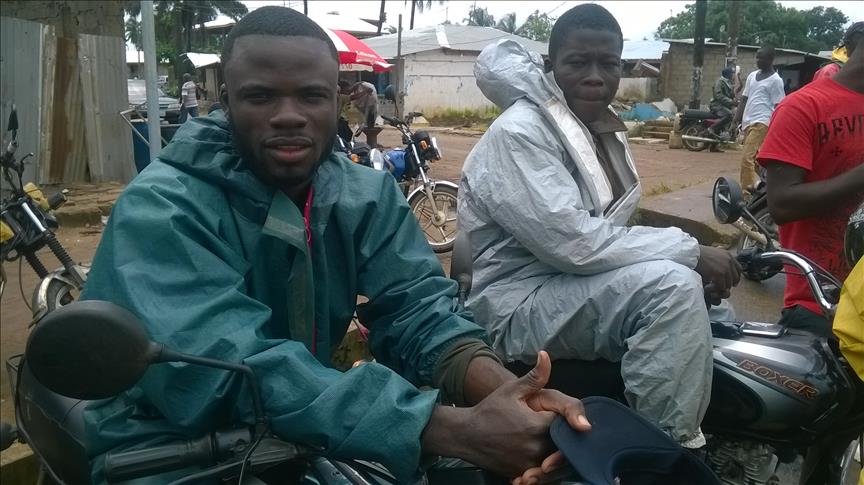 Liberian bikers use Ebola suits as raincoats