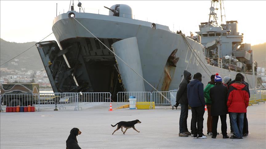 Migrants shelter from freezing cold on Greek navy ship