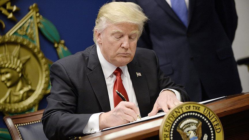 Trump signs executive order limiting refugee entry