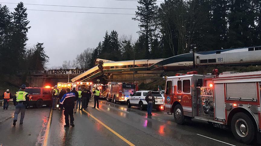 US train derails, dangles from bridge onto highway