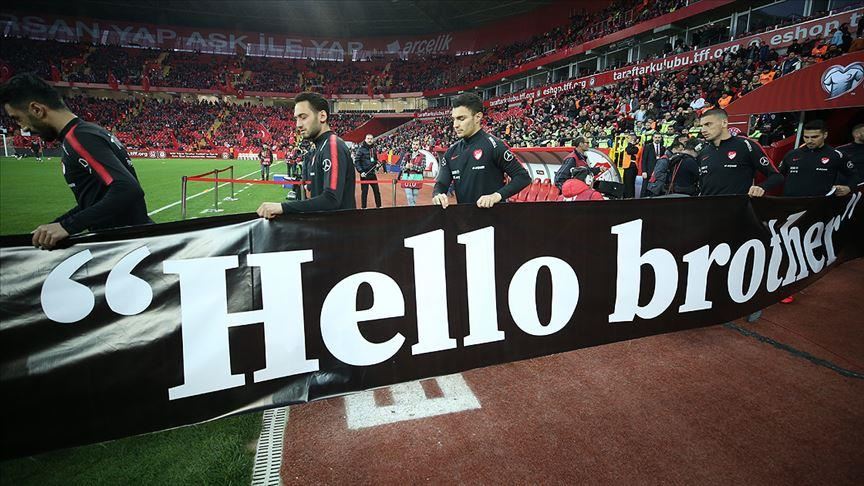 Turkish footballers hold 'Hello Brother' banners 