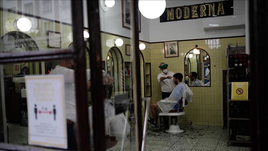 Shops reopen in Spain as country sees 164 new deaths