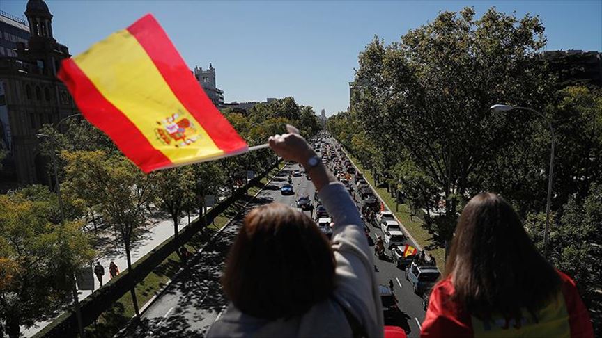 Spain: Protests, uptick in cases mark national holiday