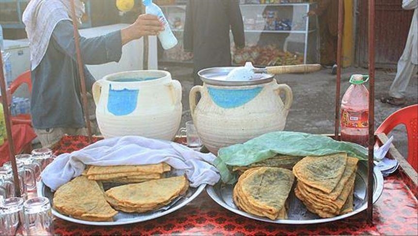 Impoverished Afghans plead for bread in front of bakeries