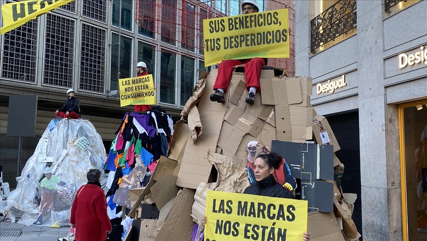Greenpeace activists protest Black Friday in Madrid with giant piles of trash