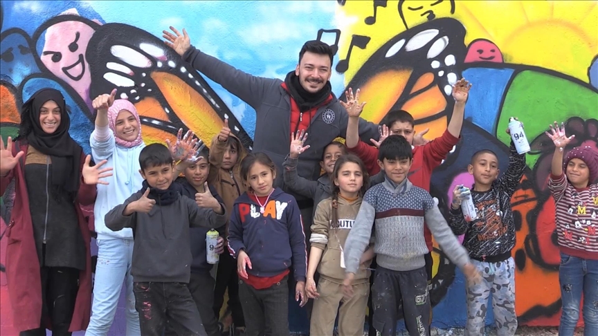 Children of Turkish tent city reflect their dreams on walls