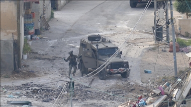 Israeli army raids West Bank cities, clashes with locals as over dozen more Palestinians held