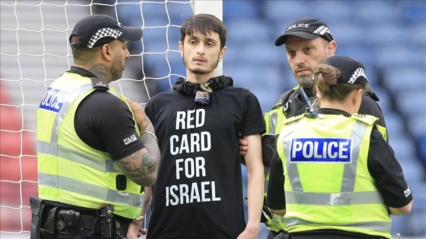 Teenager chains himself to goalpost during Scotland-Israel match to protest Israeli bombardment of Gaza Teenager chains himself to goalpost during Scotland-Israel match to protest Israeli bombardment of Gaza