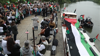 Paris pro-Palestine demonstrators decorate narrowboat on River Seine
