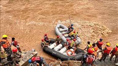 Search for 54 people in Nepal continues after floods sweep 2 buses into river