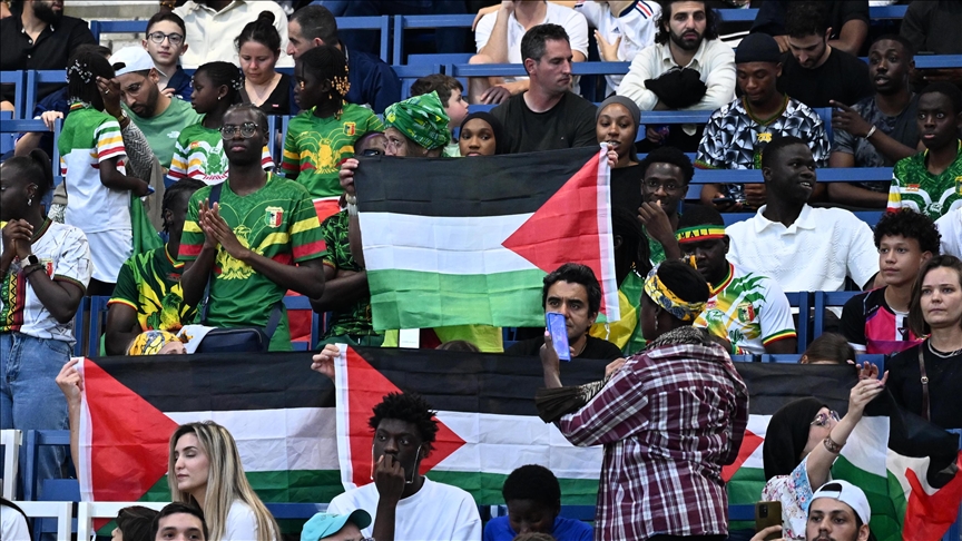 Football fans open Palestinian flag to protest Israel at Paris 2024 Olympics