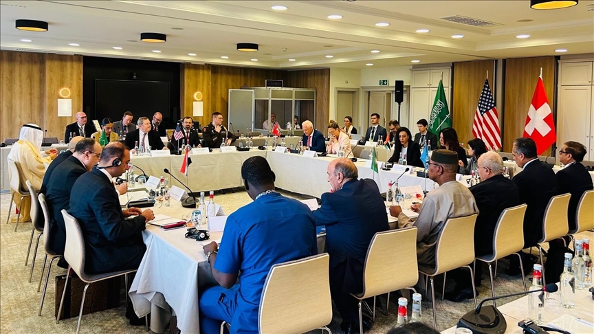US-sponsored peace talks on Sudan commence in Geneva with delegates seated around a conference table.