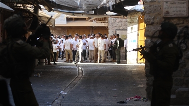 Illegal Israeli settlers escorted by security forces storm Old City of Hebron in southern West Bank