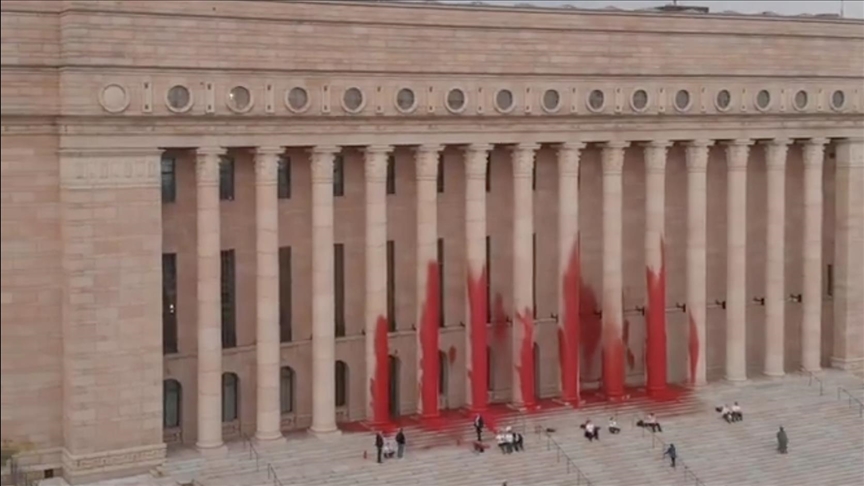 Environmentalists smear Finland’s parliament in red paint