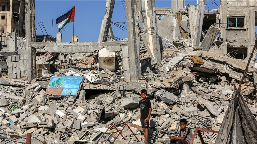 Palestinian girl carries injured sister to medical help in embattled Gaza Strip