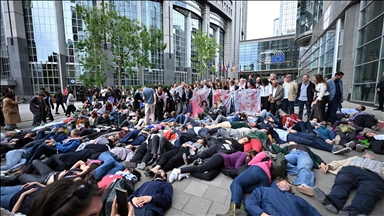  Activists lie on ground outside EU Parliament to protest Israeli strikes on Gaza