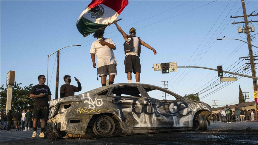 Protesters clash with police, set cars on fire amid immigration raid unrest in Los Angeles