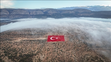 Mersin'de 22 dönümlük araziye işlenen Türk bayrağı siste görüntülendi