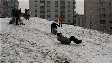 Li Erziromê zarokên ku barîna berfê wek firsend dîtin li nav taxan bi poşet û taxûkan xwe kaş kirin