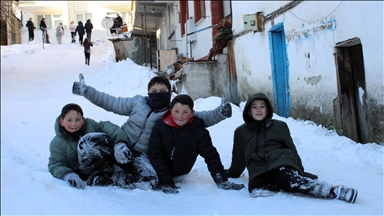 Mahalle yolunu kızak pistine çeviren çocuklar karın tadını çıkardı