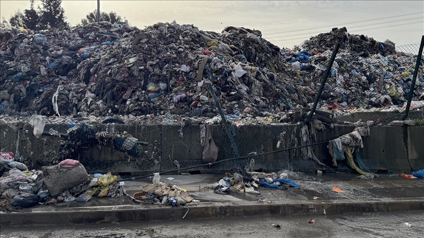 İzmir Buca'da şantiyedeki çöpler yağmur sularıyla yola dağıldı