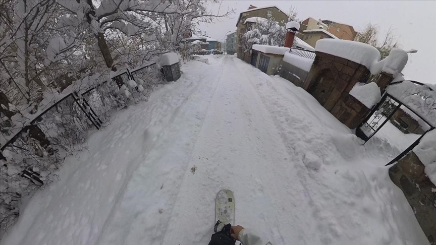 Adanalı genç diş hekiminin karla kaplı Erzurum sokaklarında snowboard keyfi
