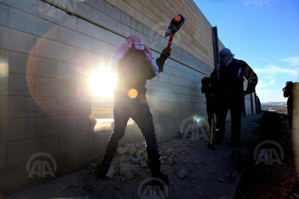 Palestinians make a hole in the Israeli West Bank barrier
