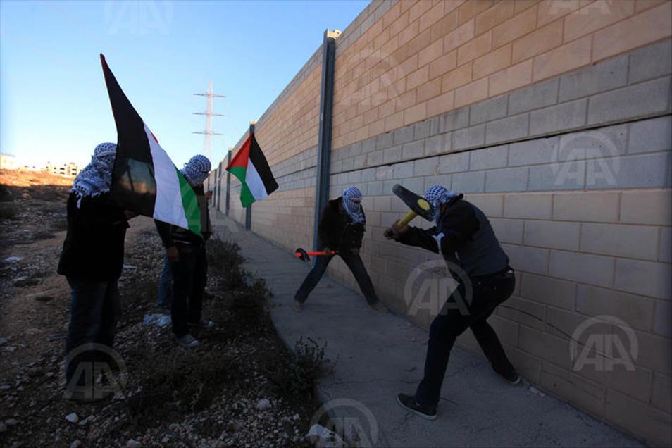 Palestinians make a hole in the Israeli West Bank barrier