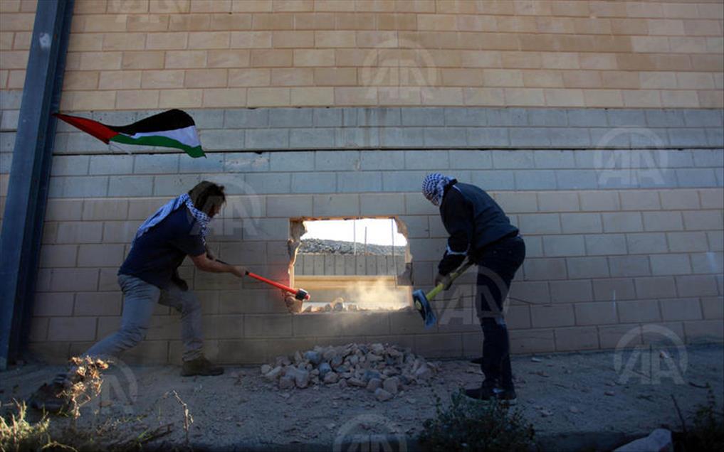 Palestinians make a hole in the Israeli West Bank barrier