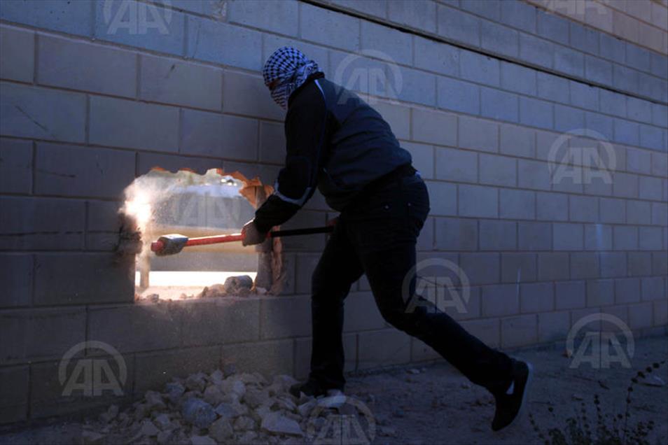 Palestinians make a hole in the Israeli West Bank barrier