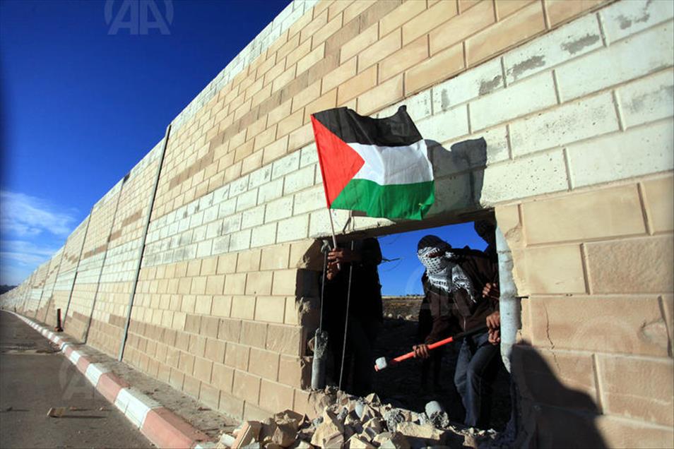 Palestinians make a hole in the Israeli West Bank barrier