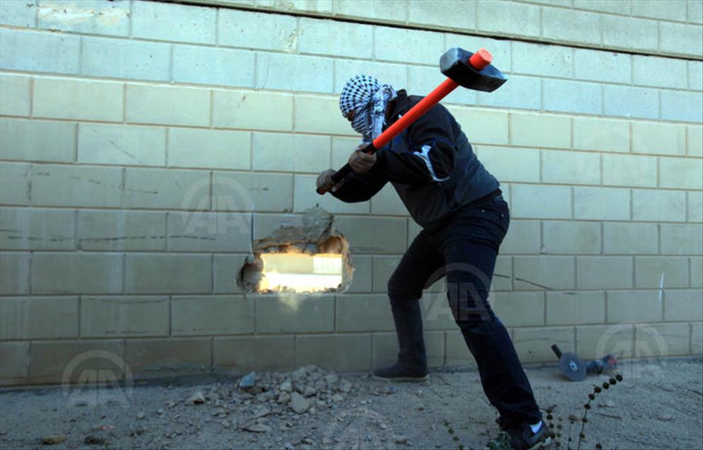 Palestinians make a hole in the Israeli West Bank barrier