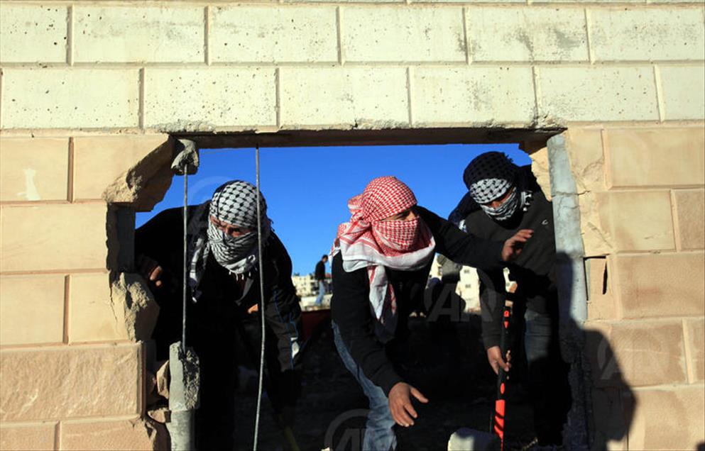 Palestinians make a hole in the Israeli West Bank barrier