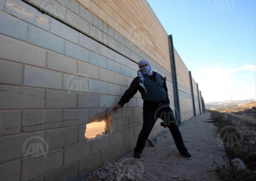 Palestinians make a hole in the Israeli West Bank barrier