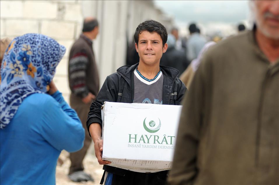 Hayrat Humanitarian Aid Association members set up a village by Syrian families