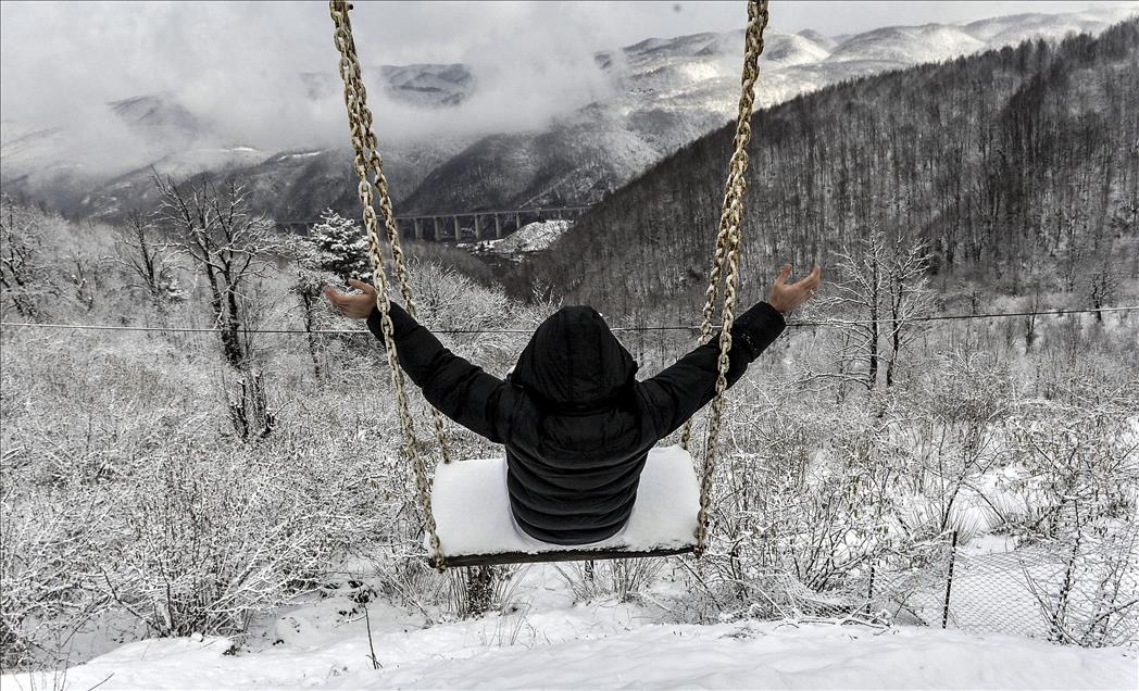 Man rides on swing in Duzce after snowfall