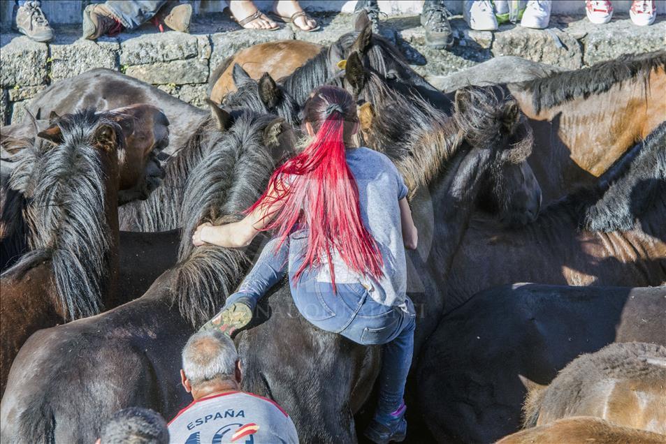 A woman rides a horse