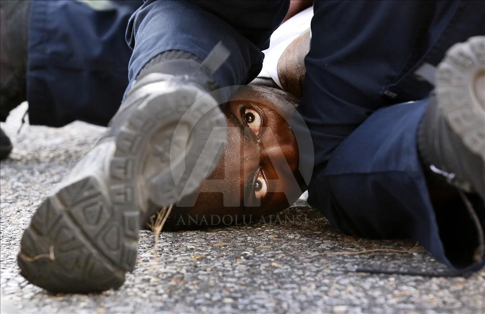 A man is detained by law enforcement while protesting the shooting death of Alton Sterling outside the headquarters of the police department in Baton Rouge, Louisiana