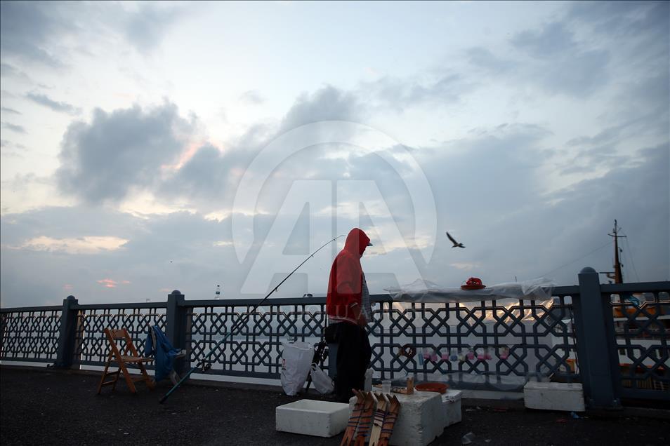 Fishing on Istanbul's Galata Bridge at sunrise