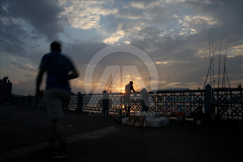 Fishing on Istanbul's Galata Bridge at sunrise