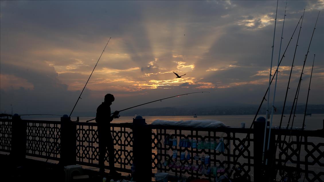 Fishing on Istanbul's Galata Bridge at sunrise