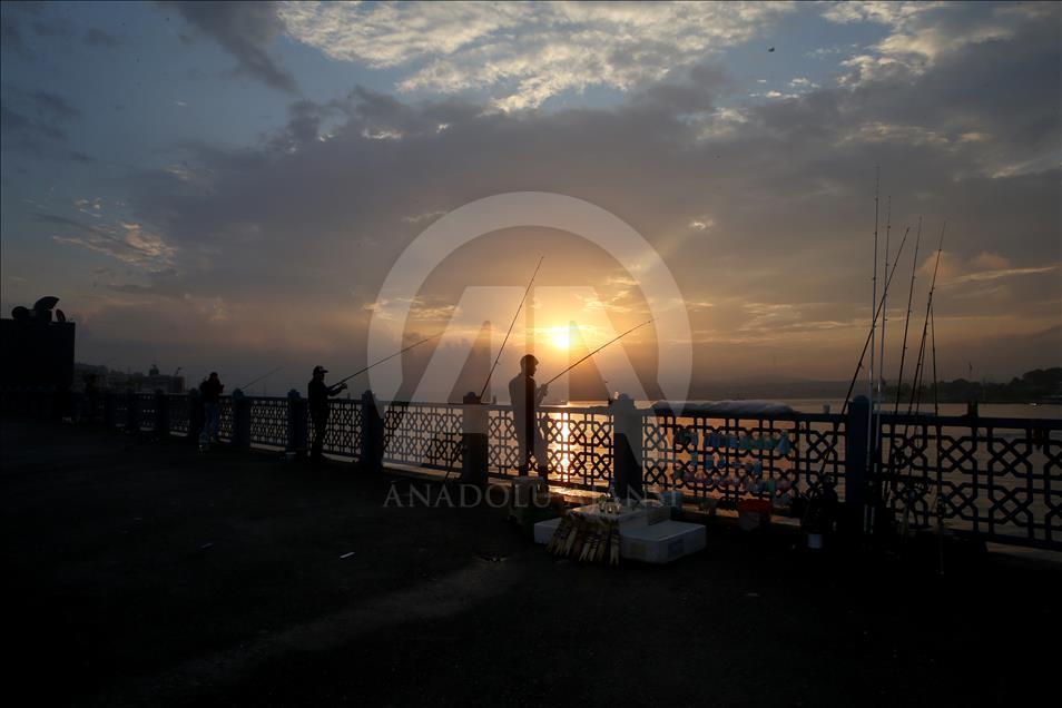 Fishing on Istanbul's Galata Bridge at sunrise