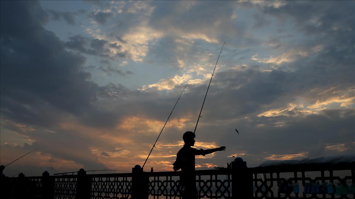 Fishing on Istanbul's Galata Bridge at sunrise