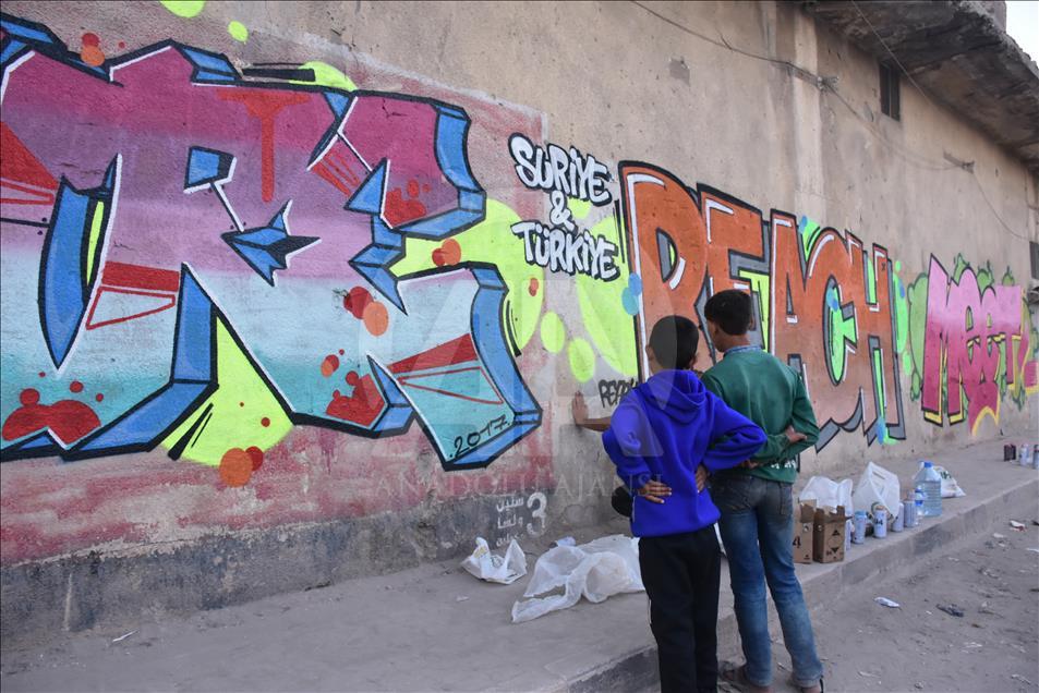 Türk grafiti sanatçılarından Suriye'de anlamlı çizimler