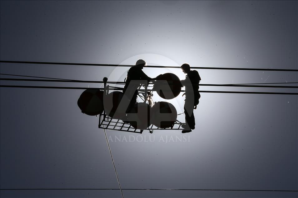 High-voltage transmission line workers in Turkey's Van