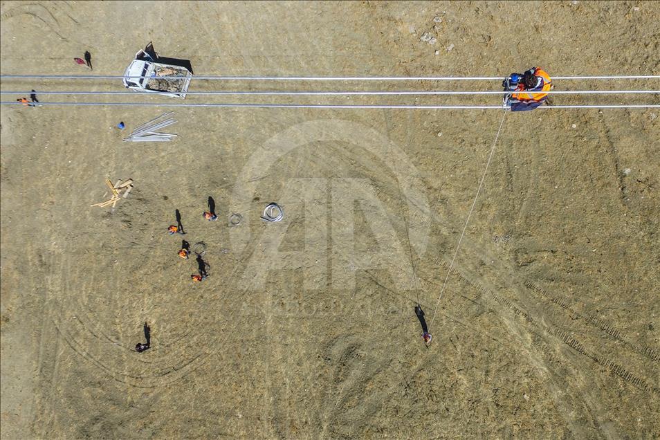 High-voltage transmission line workers in Turkey's Van