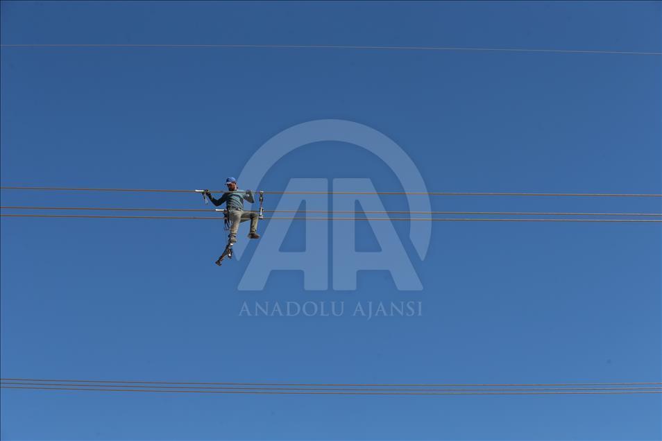 High-voltage transmission line workers in Turkey's Van
